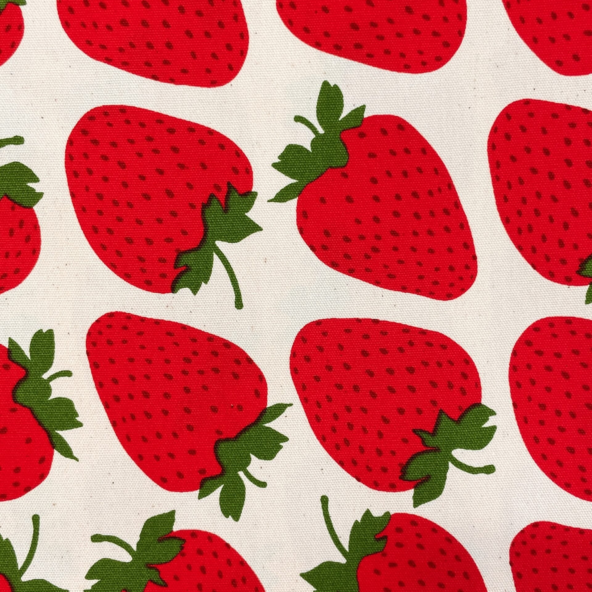 Pattern of red strawberries with green leaves on a beige background