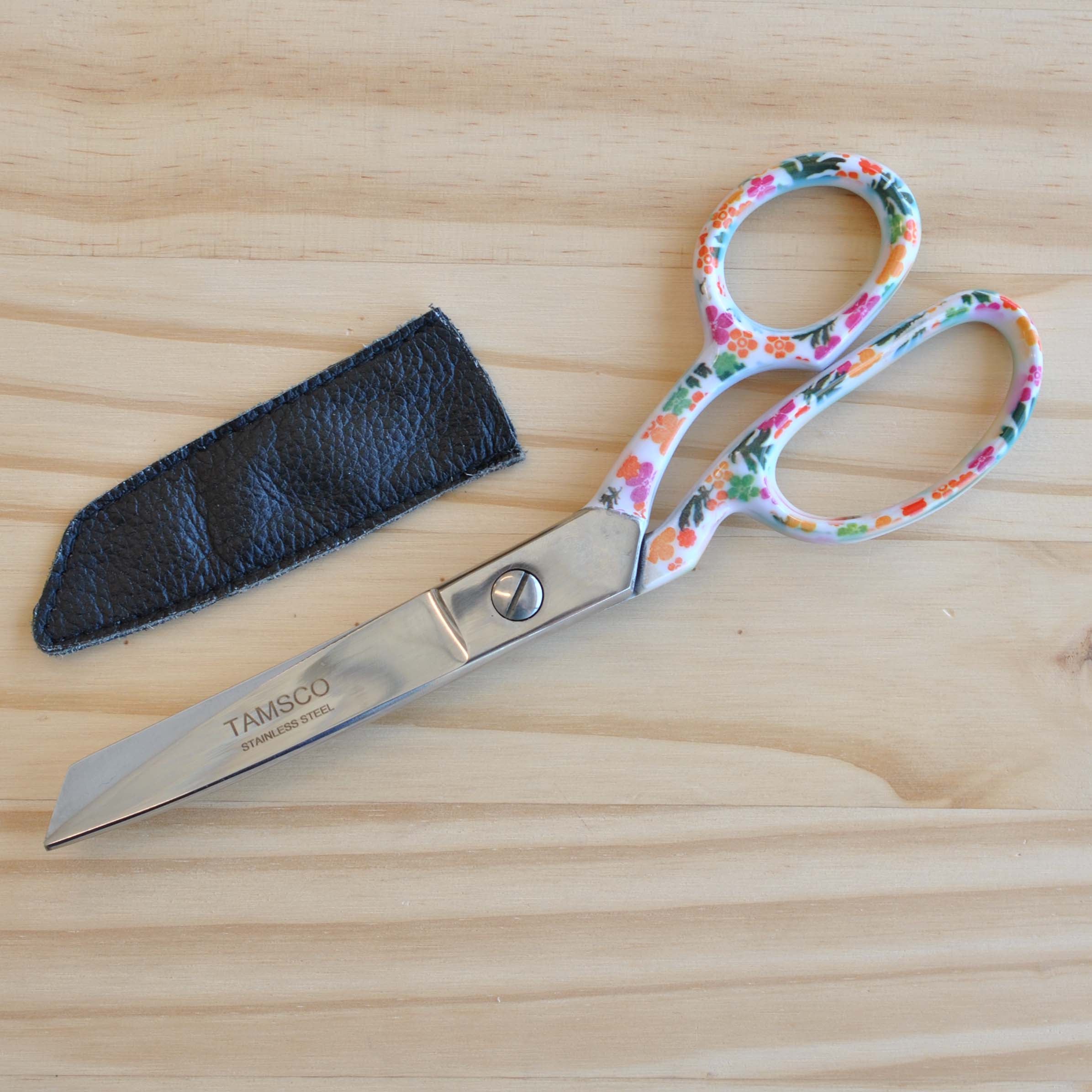 Stainless steel fabric sheers with a decorative floral design on the handles.