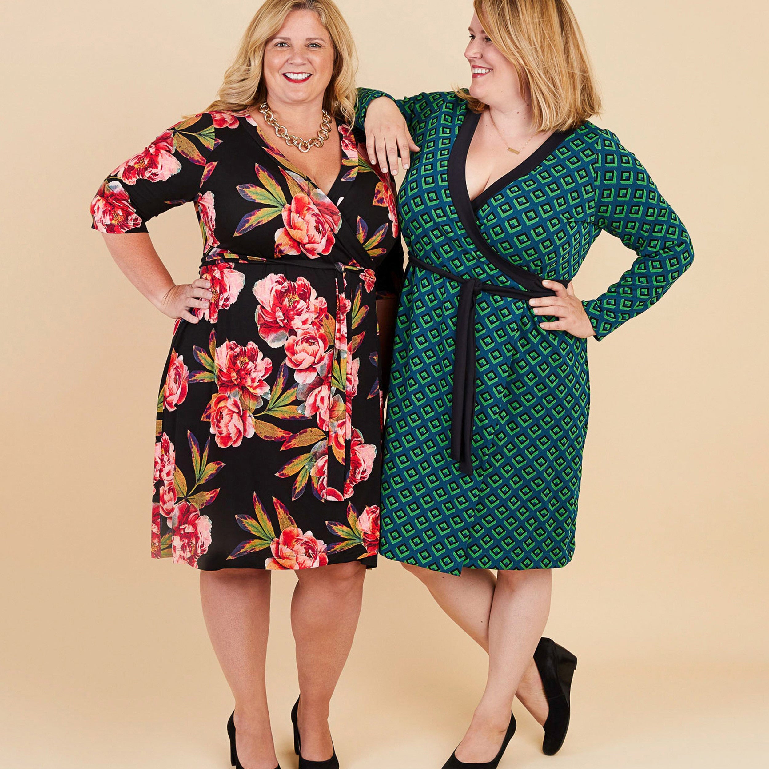 Two women wearing floral and patterned dresses on a beige background. This dress is the Appleton Wrap Dress sewing pattern from Cashmerette.