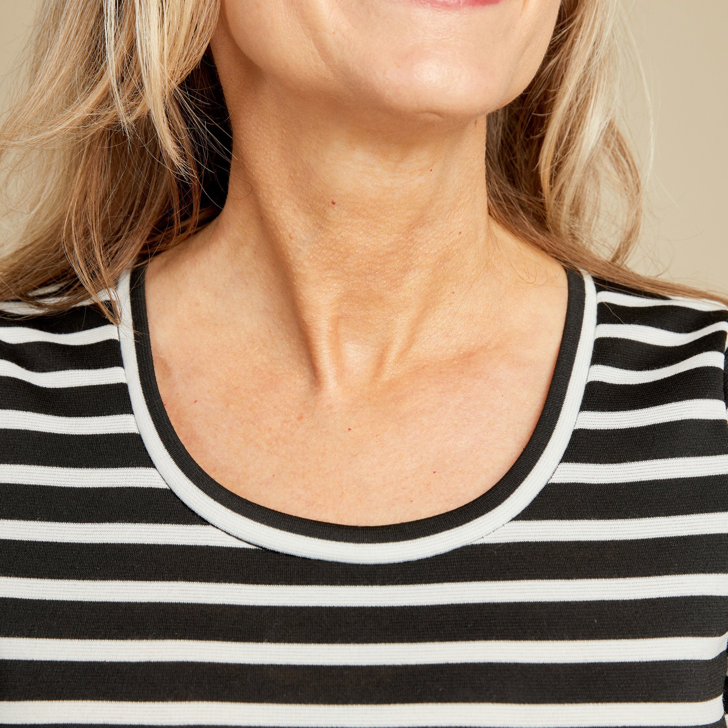 Close-up of a person wearing a black and white striped shirt. This t-shirt is the Concord T-Shirt sewing pattern from Cashmerette.