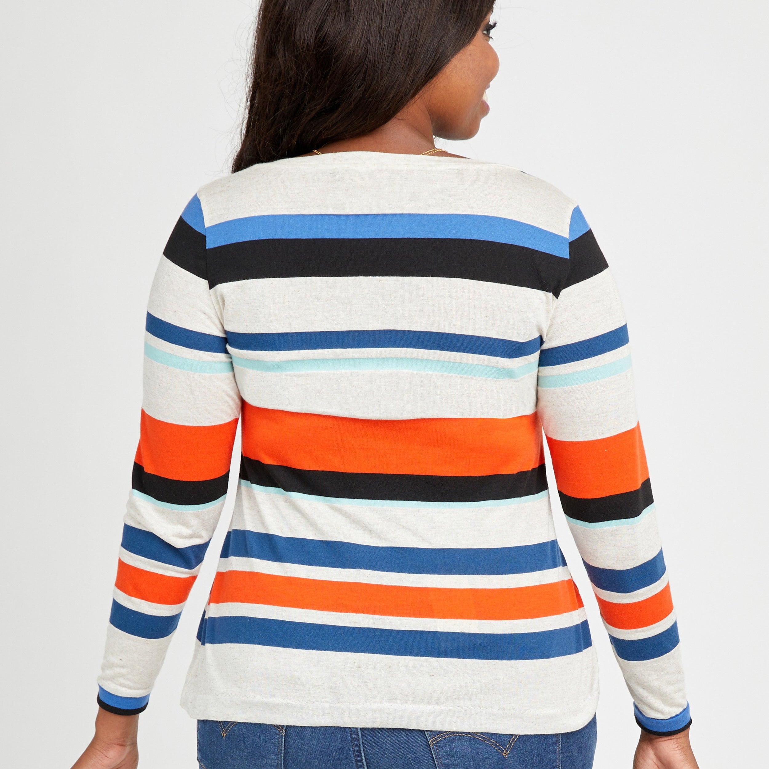 Woman wearing a striped long-sleeve shirt with a white background. This t-shirt is the Concord T-Shirt sewing pattern from Cashmerette.