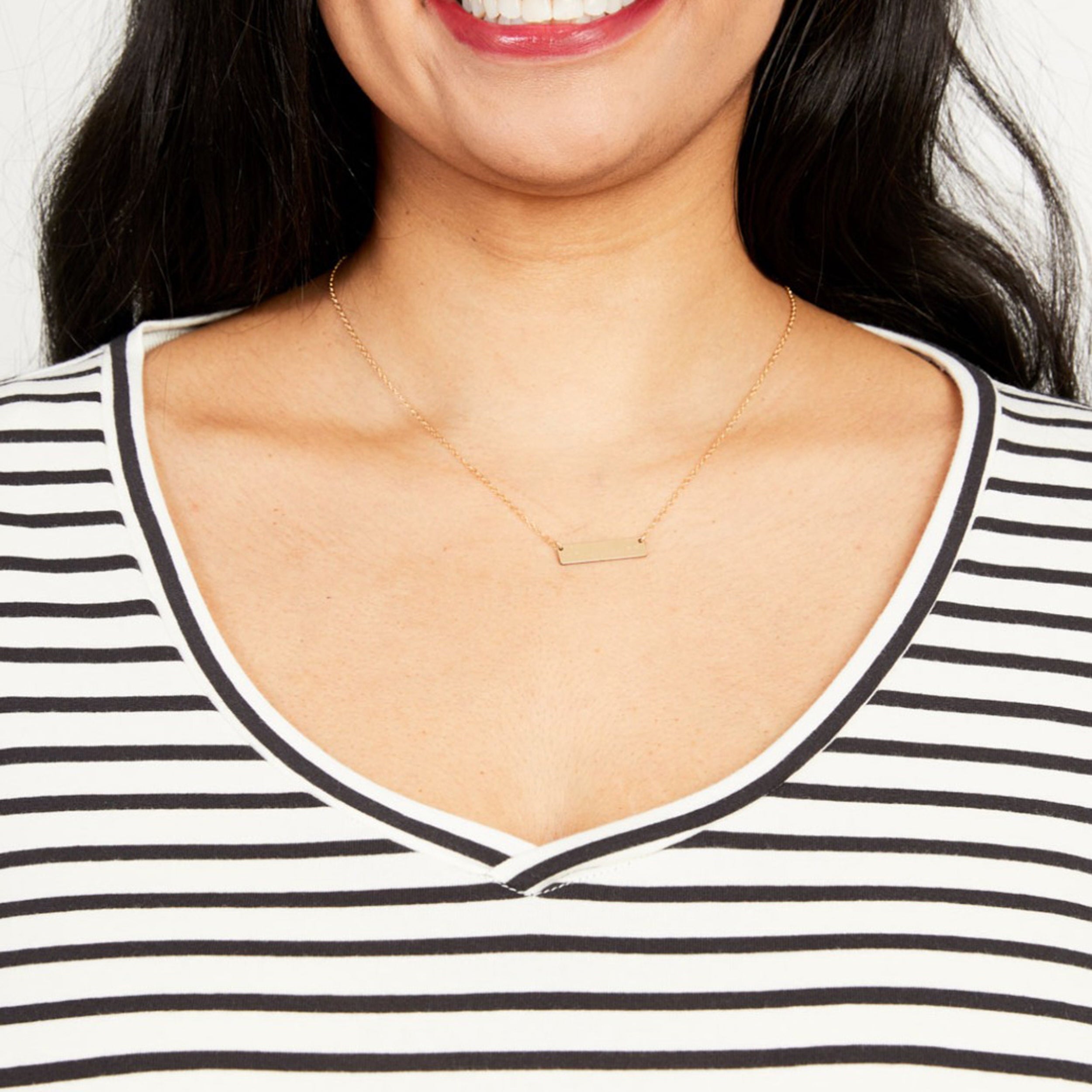 Woman wearing a gold necklace with a white and black striped shirt. This t-shirt is the Concord T-Shirt sewing pattern from Cashmerette.