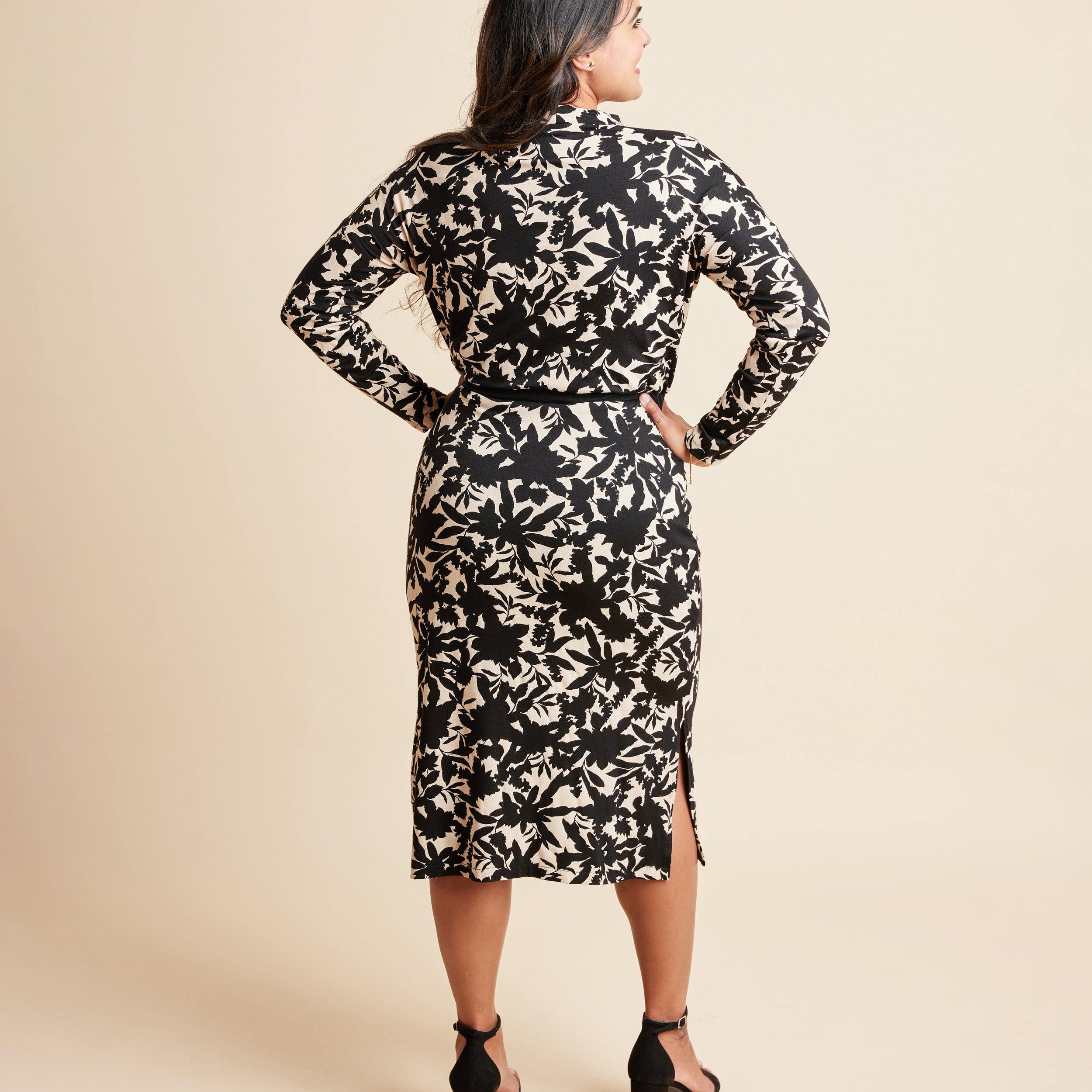 Woman wearing a black and beige floral dress against a beige background. This is the Grafton Dress, Top & Skirt sewing pattern from Cashmrette.
