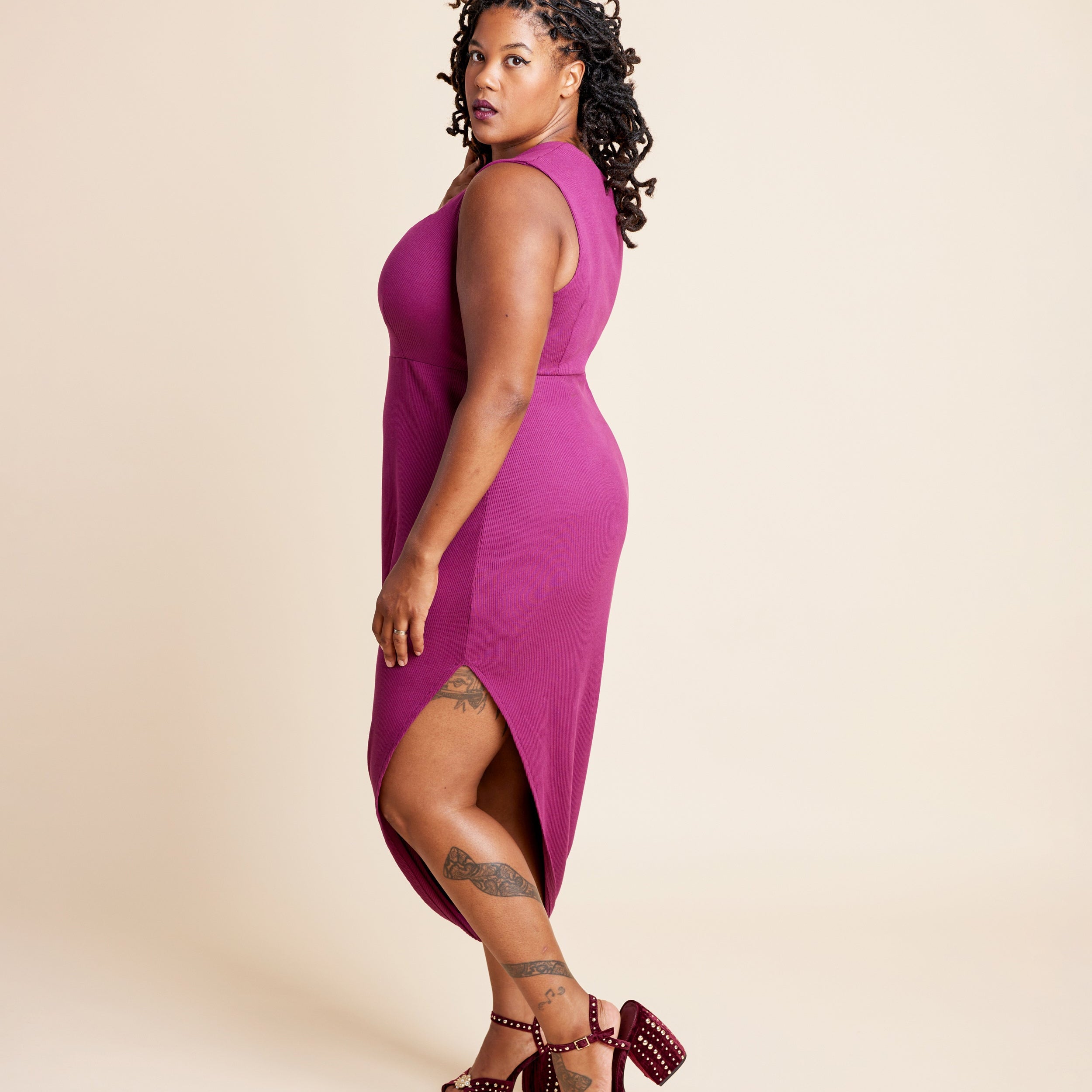 Woman wearing a magenta dress with a plain background. This is the Grafton Dress, Top & Skirt sewing pattern from Cashmerette.