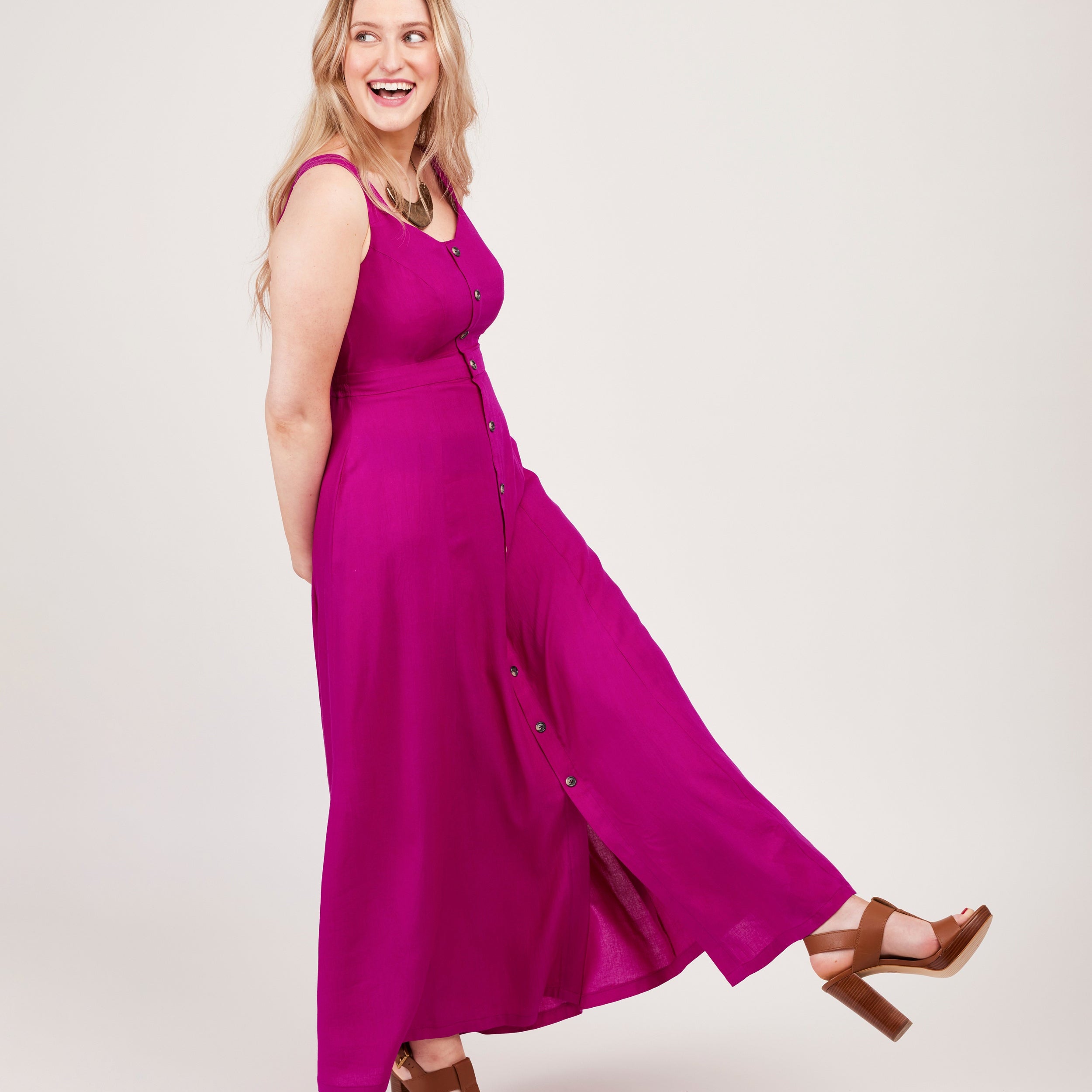 Woman wearing a bright pink dress on a white background. This is the Holyoke Maxi Dress & Skirt sewing pattern from Cashmerette.