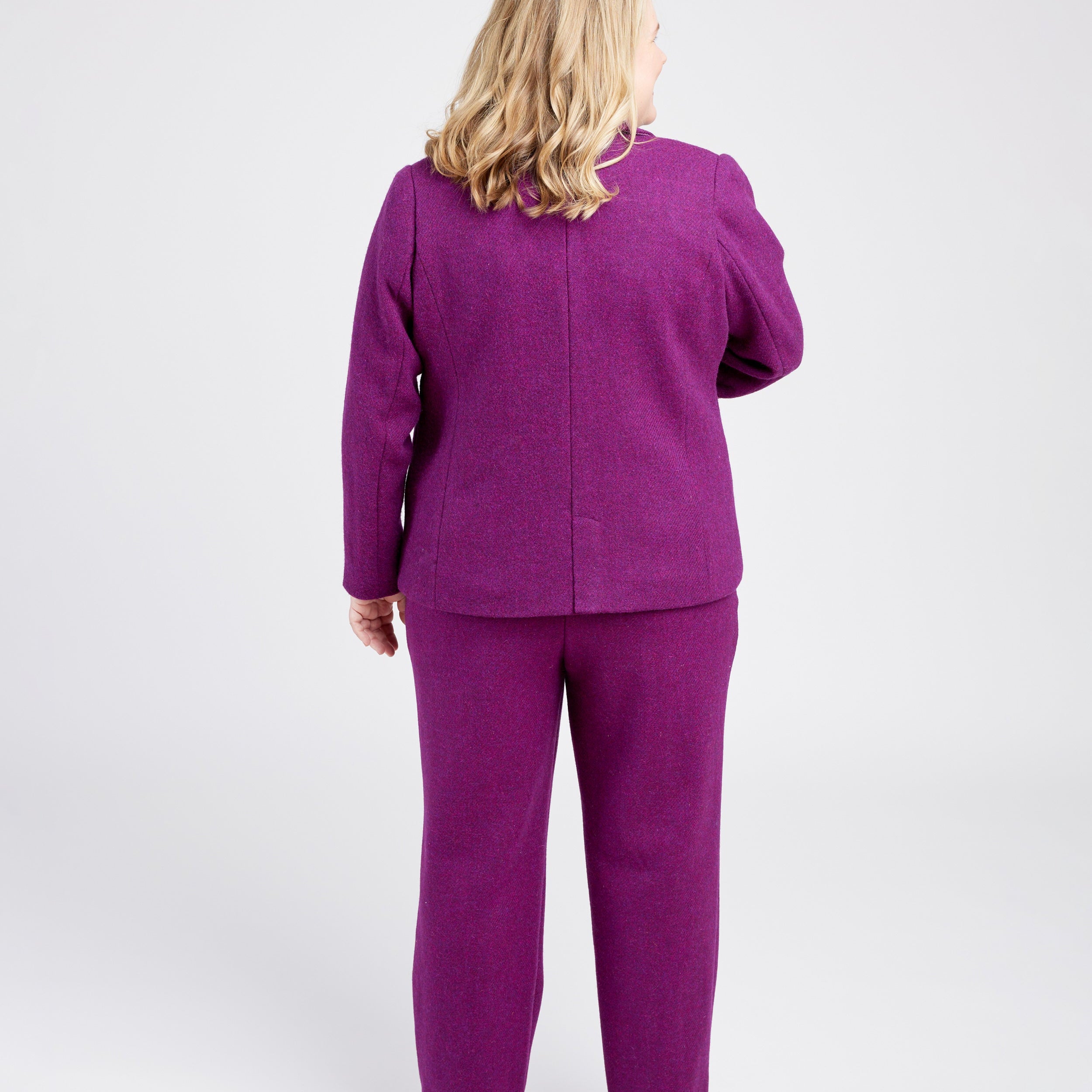 Person wearing a purple outfit on a white background. These pants are the Meriam Trousers sewing pattern from Cashmerette.