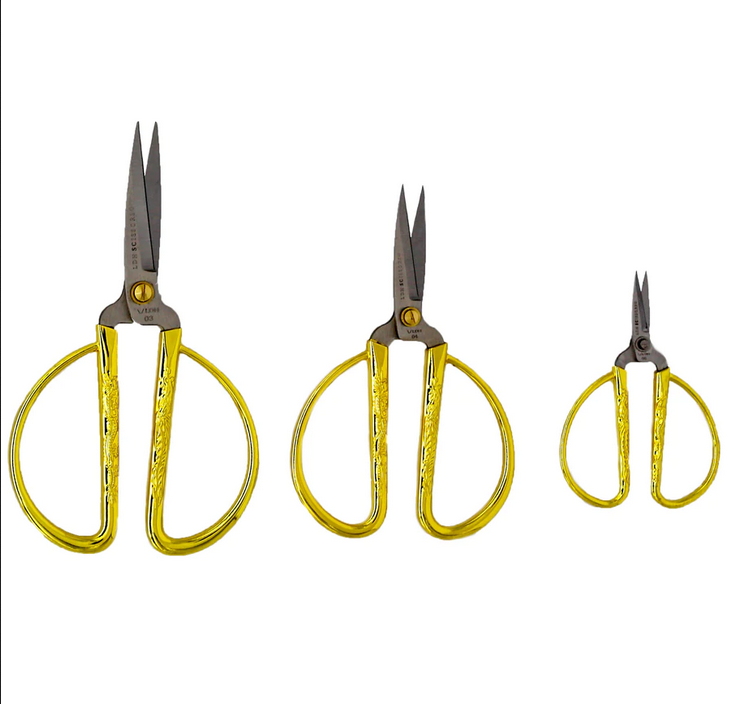 Three sizes of gold handled embroidery scissors.