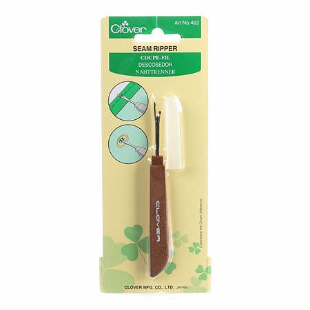 Seam ripper with brown handle and cap.