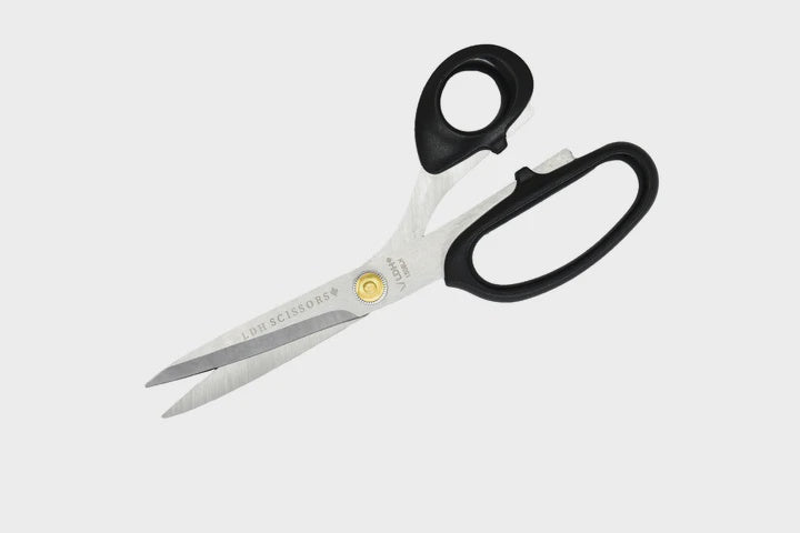 Black handled fabric scissors.