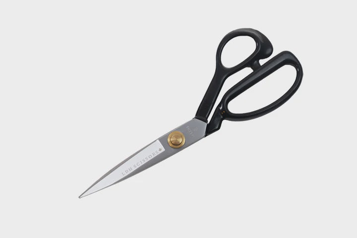 Carbon steel fabric shears with rubber handle.