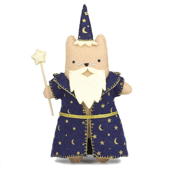 Toy cat dressed as a wizard with a blue robe, hat, and holding a wand on a white background