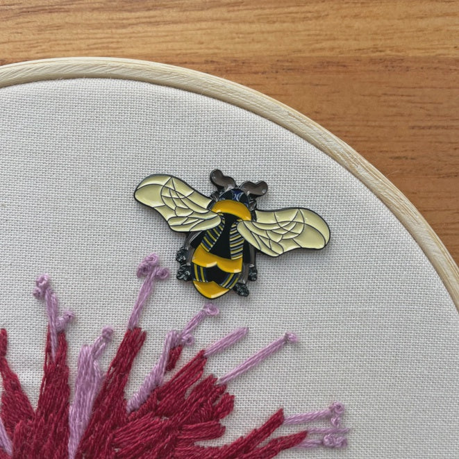 Bee shaped needle minder.