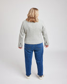 Person wearing a gray jacket and blue jeans on a white background. This biker jacket is the Canton Moto Jacket sewing pattern from Cashmerette.