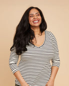 Woman wearing a black and white striped shirt against a beige backgroundThis t-shirt is the Concord T-Shirt sewing pattern from Cashmerette.