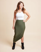 Woman wearing a white top and green skirt on a beige background. This is the Grafton Dress, Top & Skirt sewing pattern from Cashmrette.