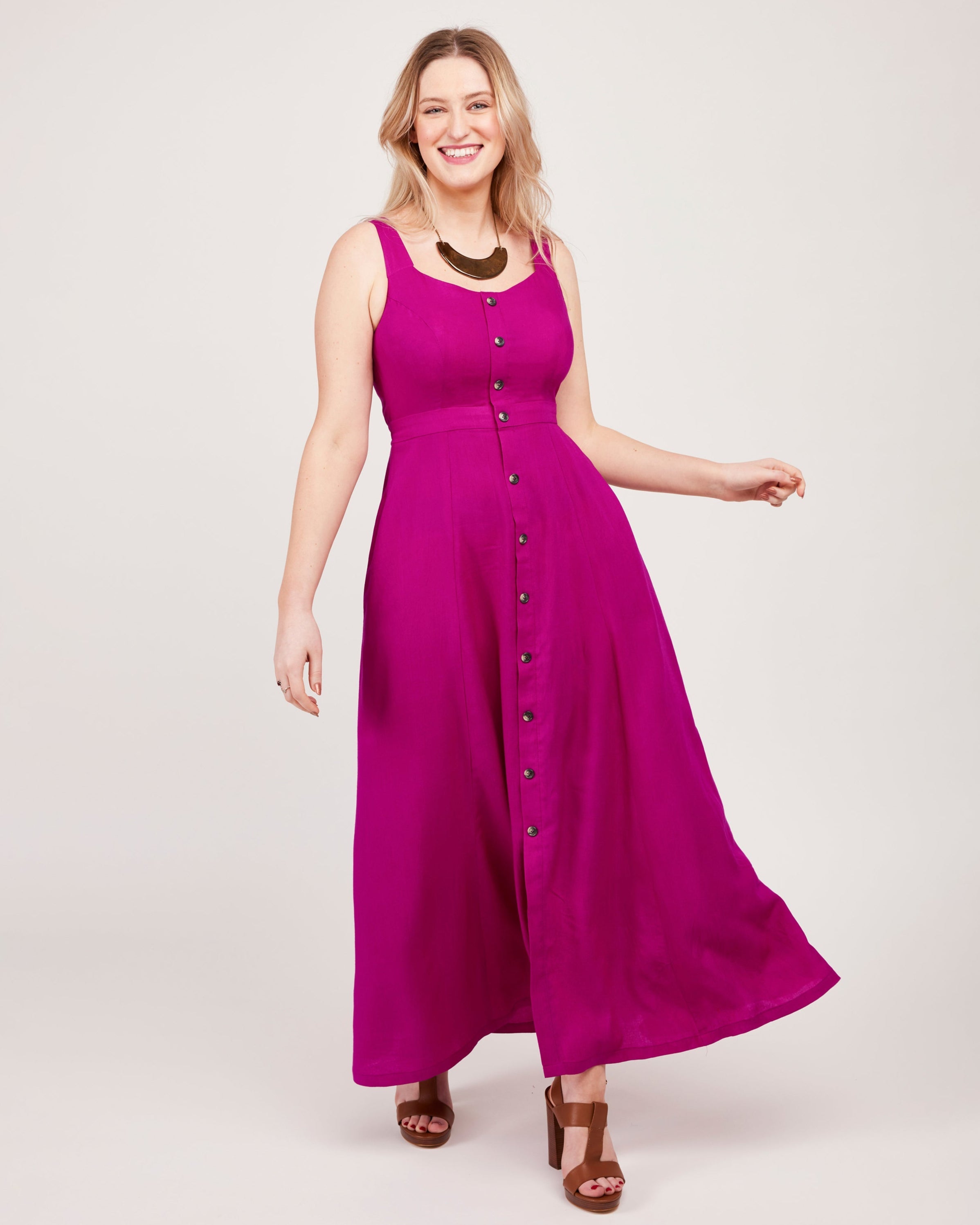 Woman wearing a pink dress with buttons on a white background. This is the Holyoke Maxi Dress & Skirt sewing pattern from Cashmerette.