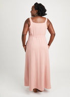 Woman wearing a pink sleeveless dress on a white background. This is the Holyoke Maxi Dress & Skirt sewing pattern from Cashmerette.