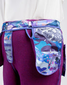 Purple pants worn inside out with colorful designs on a white background. These pants are the Meriam Trousers sewing pattern from Cashmerette.