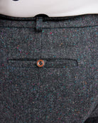 Close-up of a gray textured fabric with a button on a white background. These pants are the Meriam Trousers sewing pattern from Cashmerette.