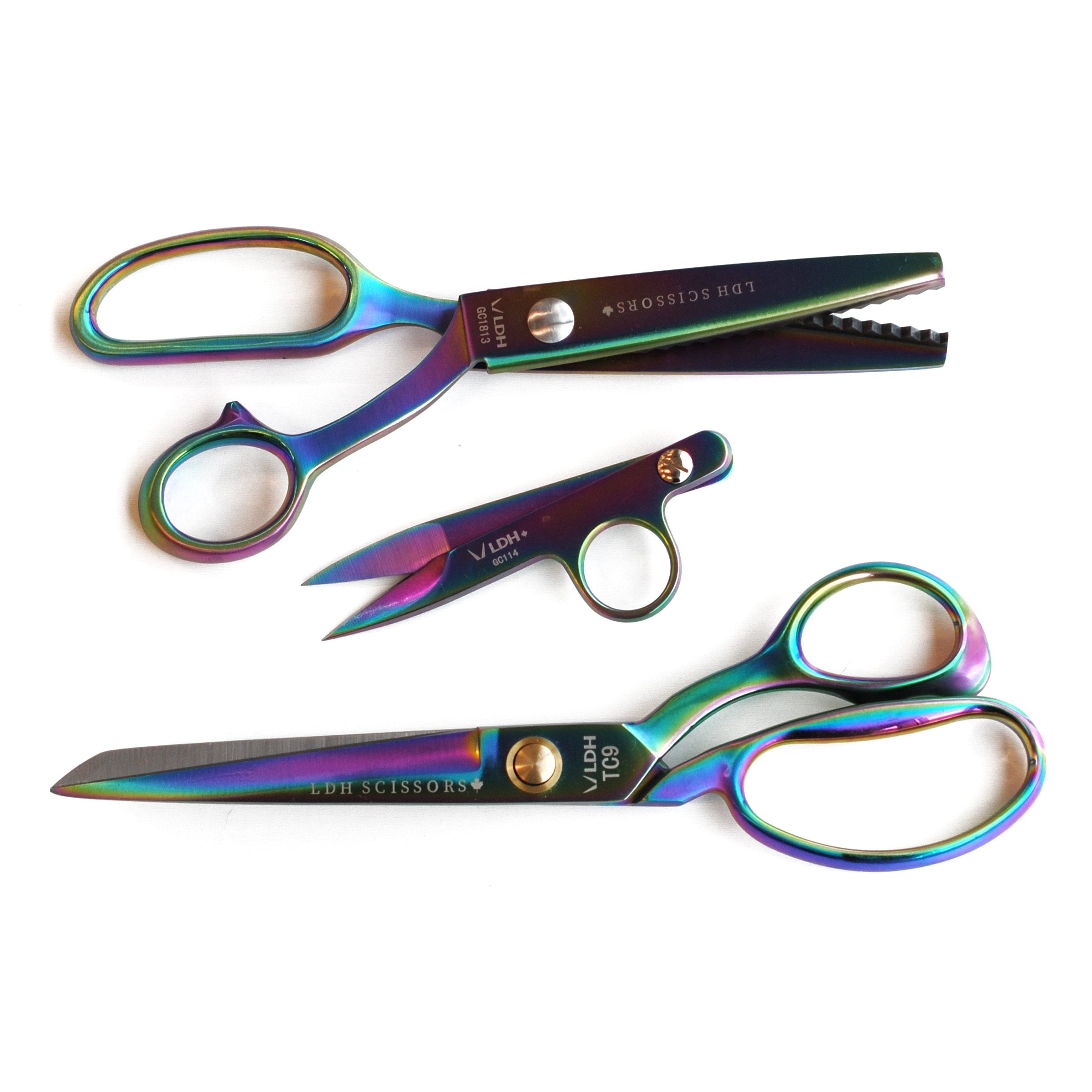 Iridescent coloured Prism Fabric Shear 9”, Prism Pinking Shear, and Prism Thread Snip.